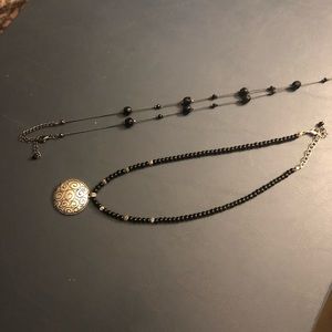 Set of two black necklaces.